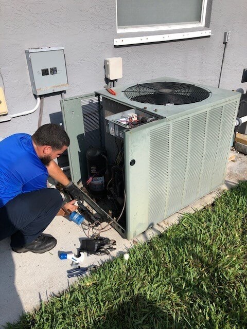 Reliable AC Repair Near Me Man Working on AC System in Port St Lucie