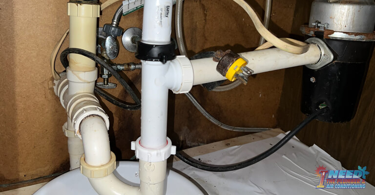 under kitchen sink mess with garbage disposal